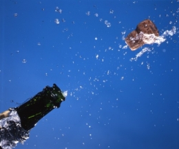 champagne-cork-popping-flying-water-liquid-drops-on-blue-ajhd.jpg